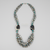 A striking one-of-a-kind handcrafted statement necklace from the Billielephante Jewelry Collection, featuring layers of natural Labradorite chips with their characteristic gray tones and subtle flashes of blue and green.

The necklace is accented with vibrant Turquoise beads, ornate German silver-tone components, and dramatic faceted Tiger Agate stones. Multiple strands of irregular Labradorite create wonderful texture and movement, while the oversized dark stones and detailed silver-tone spacers give the p